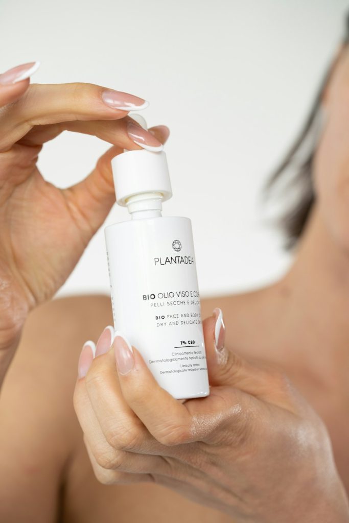 a-woman-holding-a-bottle-of-skin-care-product-jbbnnnyp-ck